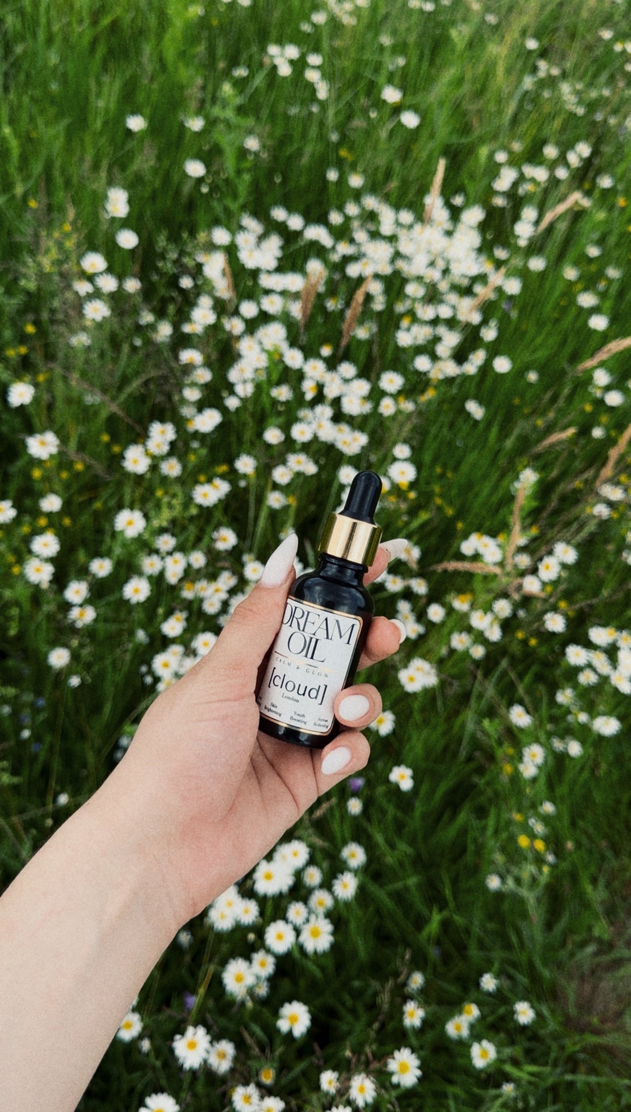 Dream Oil being held in the hand 